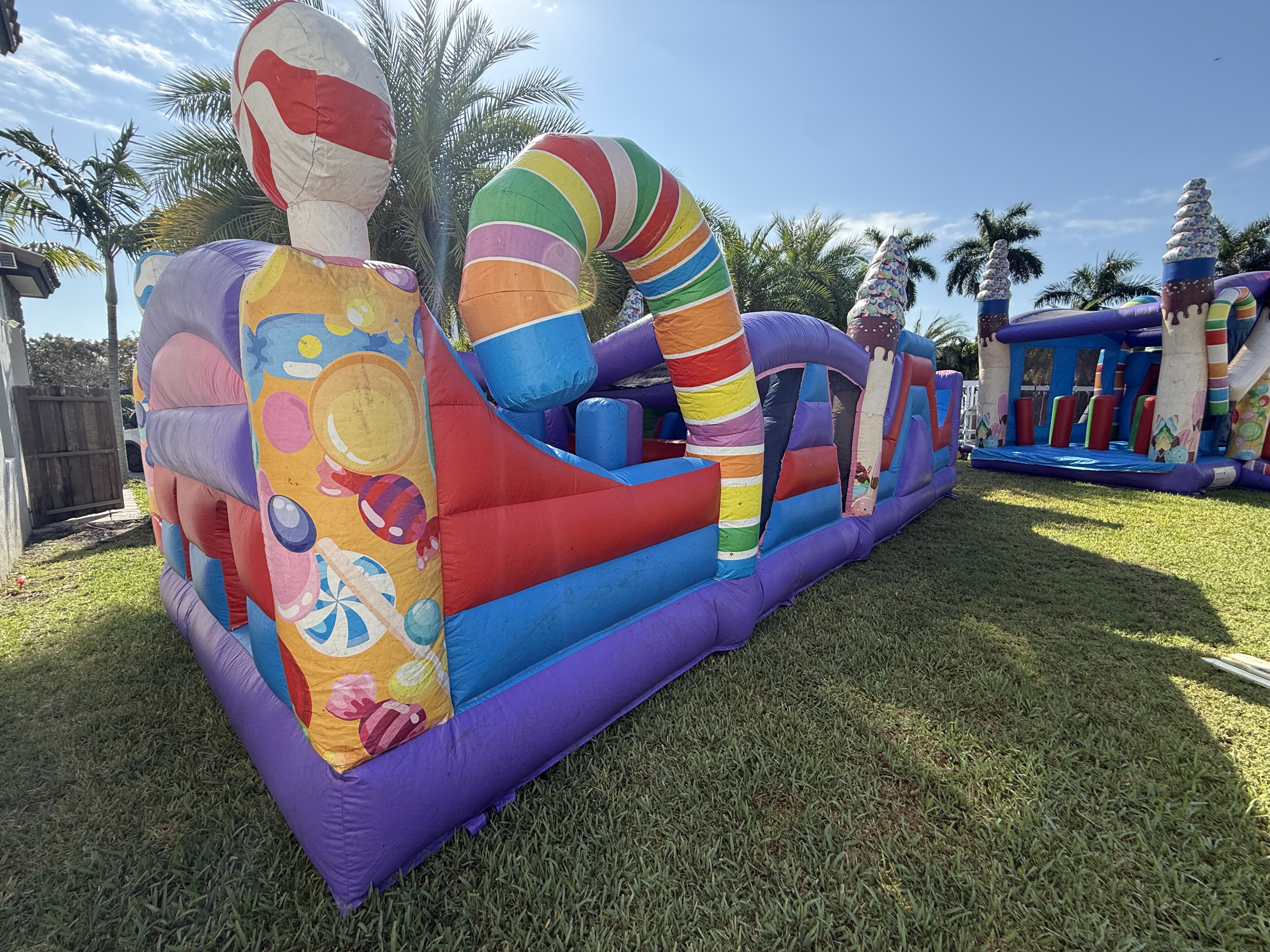 Kids jumping in a colorful bounce house at a Miami backyard party